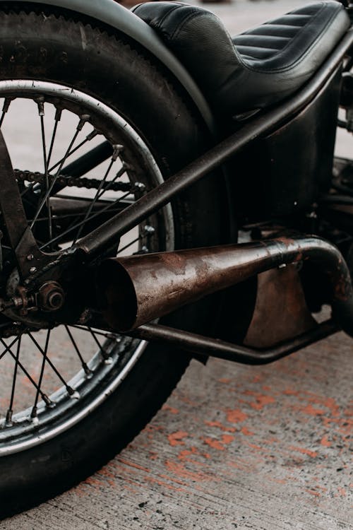 Motorbike with leather saddle and exhaust pipe