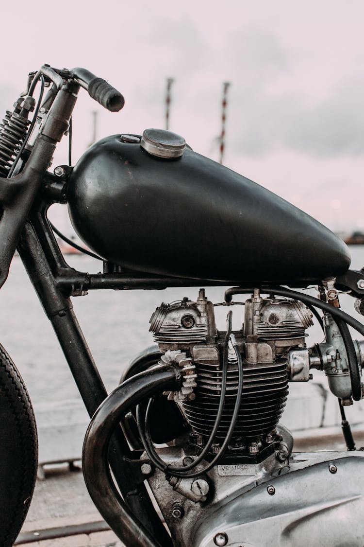 Motorbike With Gas Tank And Iron Engine On River Bank