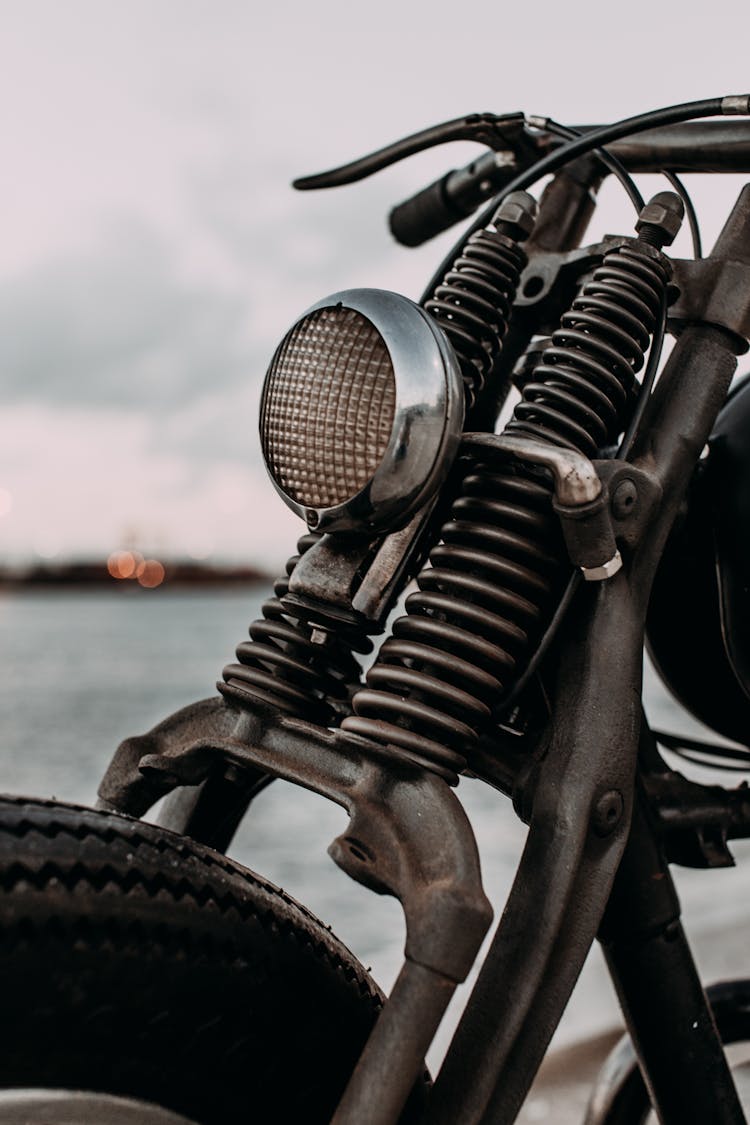 Vintage Motorbike Parked On Coast Of River