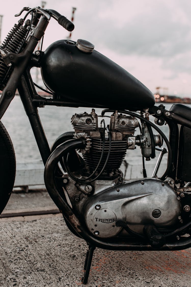 Retro Motorcycle Engine On Embankment Against Sea