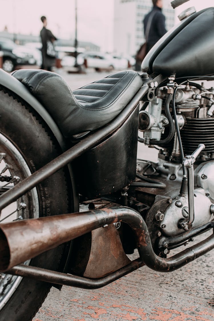 Old Fashioned Motorbike With Leather Seat In Town