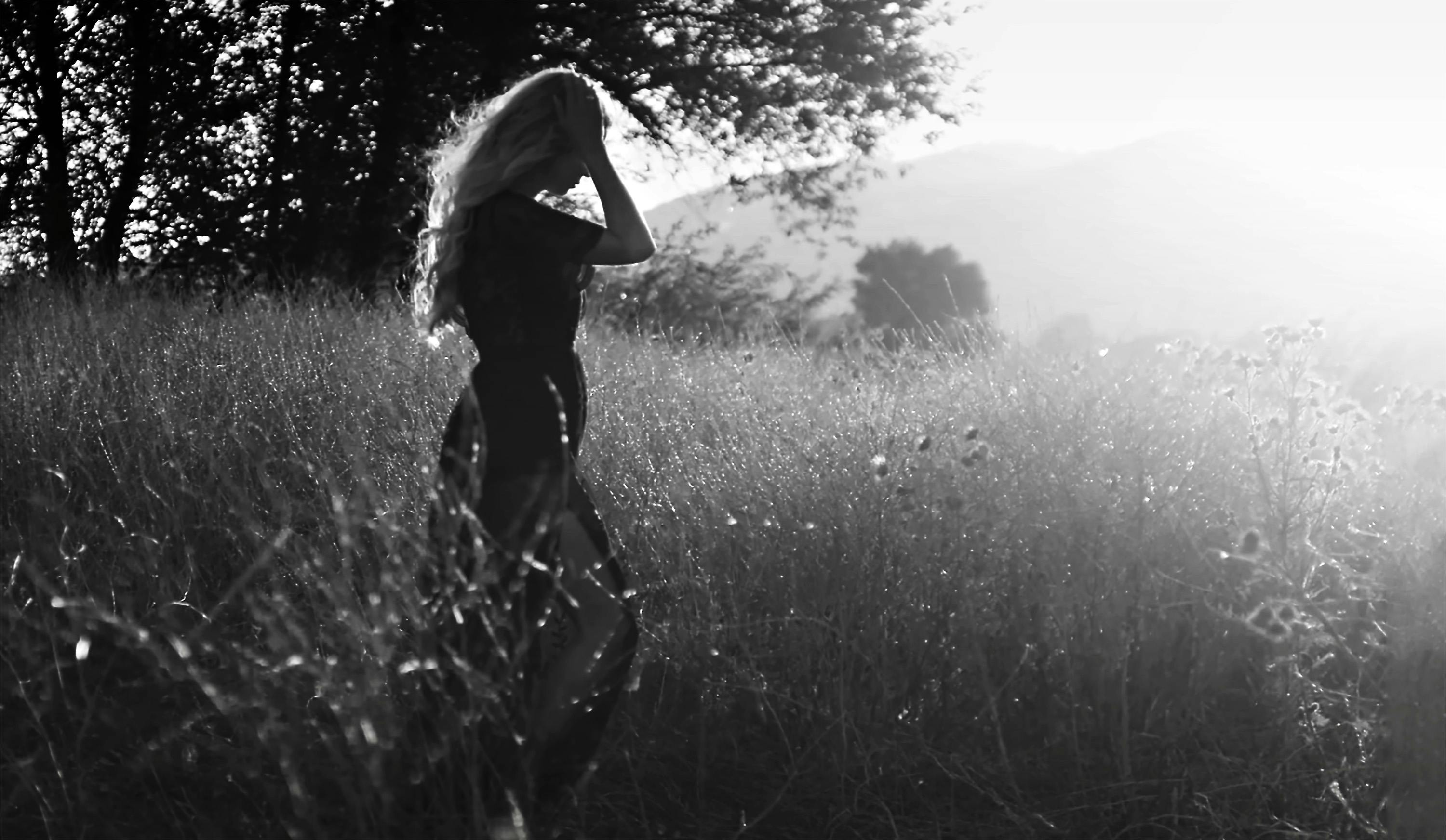 A Woman Walking Barefoot on the Grass · Free Stock Photo