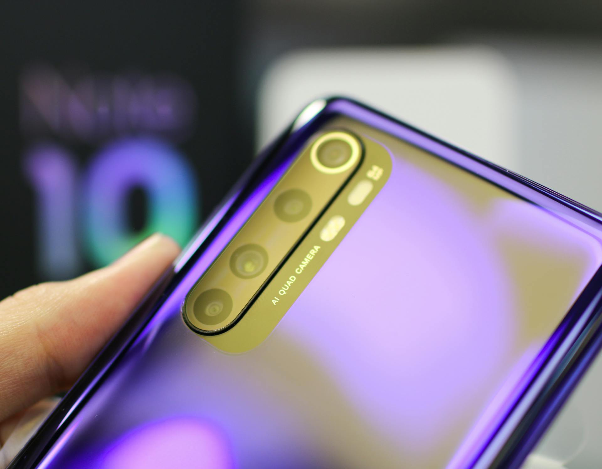 Detailed view of a smartphone with AI quad camera and reflective surface, highlighting its design.