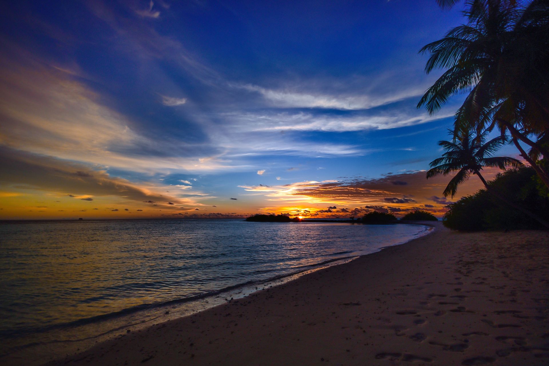 Experience tranquility with a breathtaking sunset over the beaches of Laamu Atoll in the Maldives.