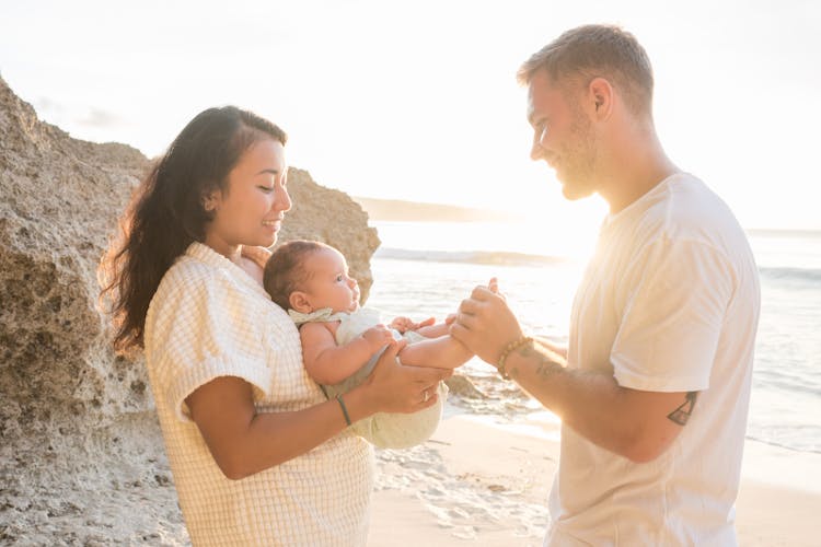 Couple With Baby On Beach