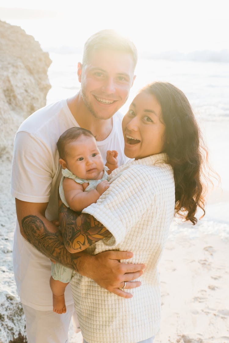 Couple With Baby On Beach