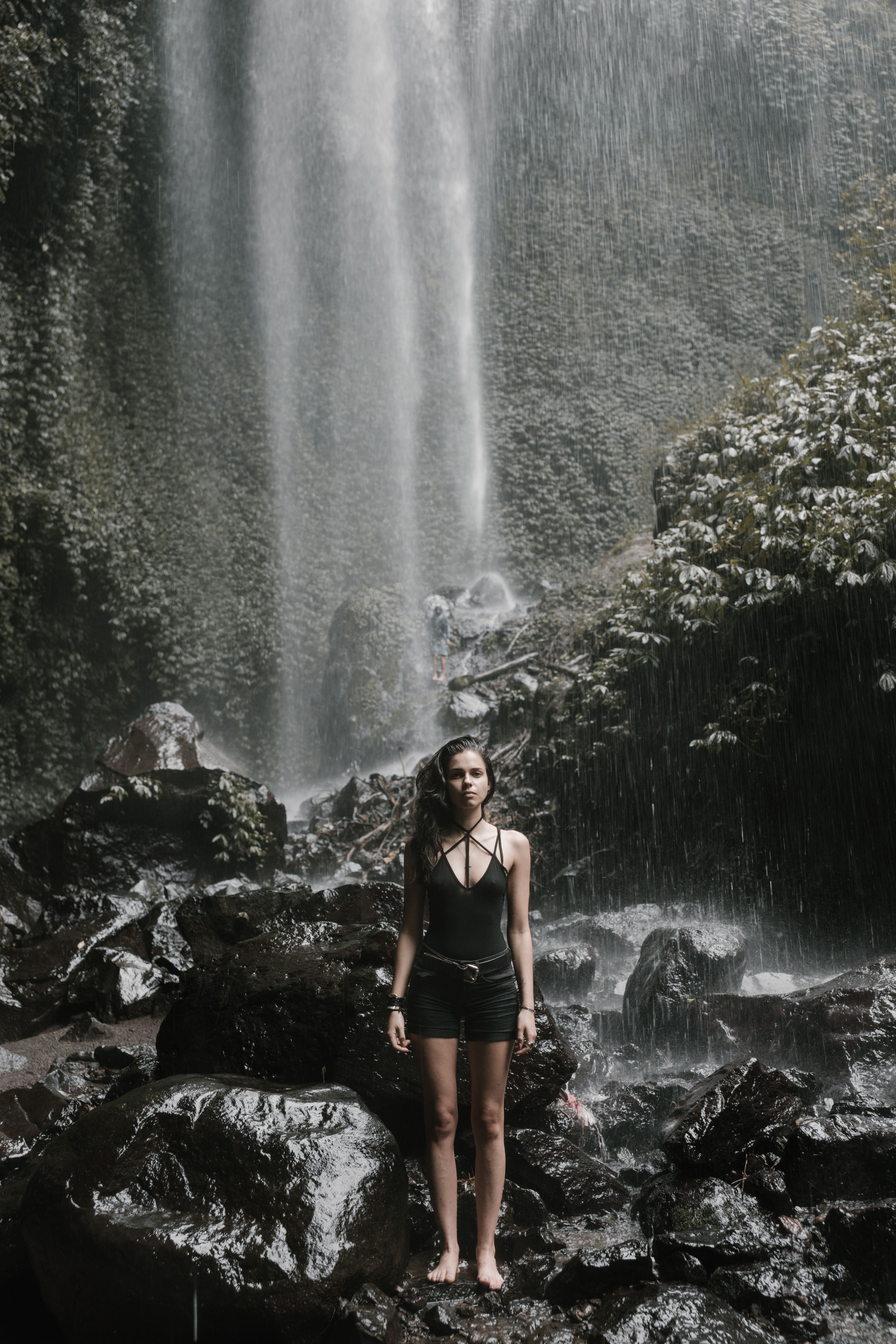 A Person Standing by a Waterfall · Free Stock Photo