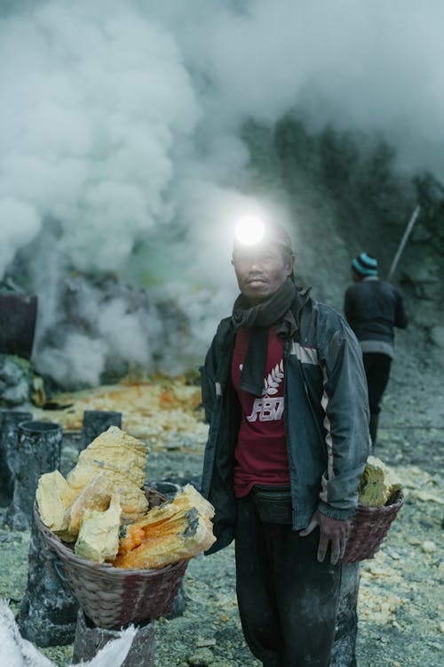 Man with Stones in Baskets