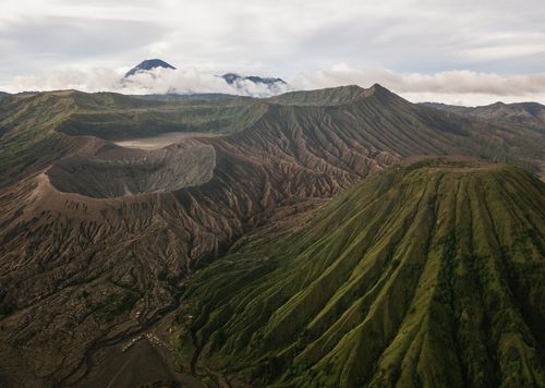 Free A stunning aerial view of Mount Bromo and its surrounding volcanic landscape on a cloudy day. Stock Photo