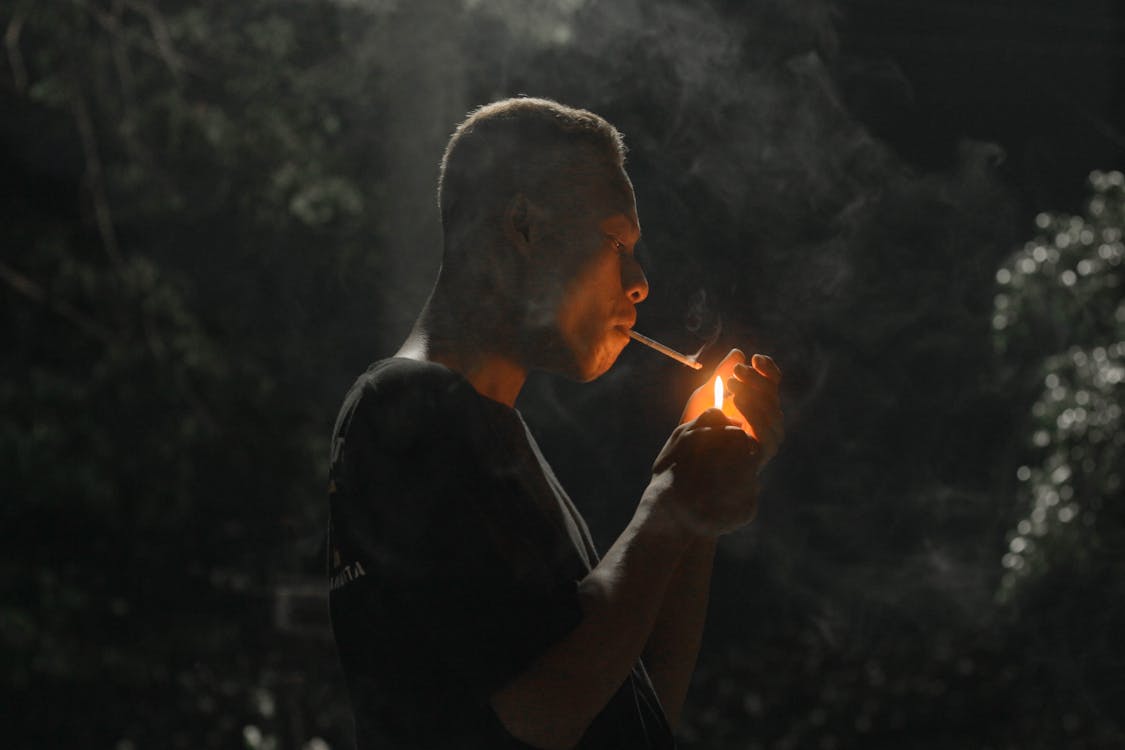 Free Man in Black Shirt Smoking Stock Photo
