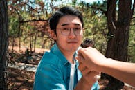 Asian man with girlfriend in summer forest