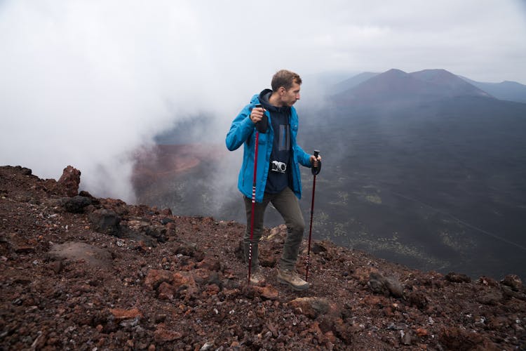 A Man Holding Hiking Sticks