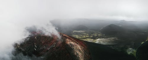 Free Volcano Crater Under White Clouds Stock Photo