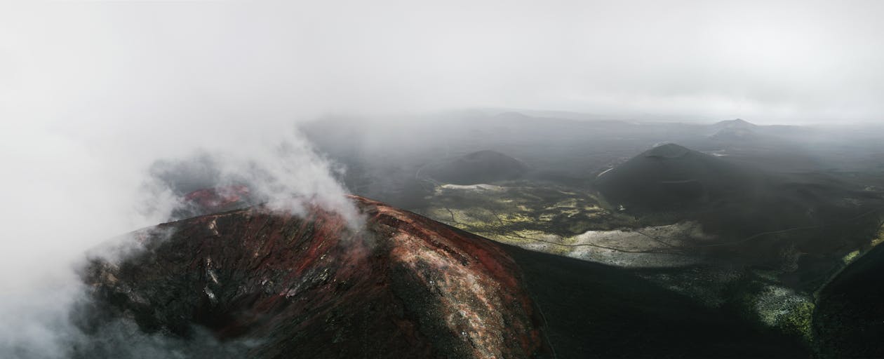 Volcano Crater Under White Clouds