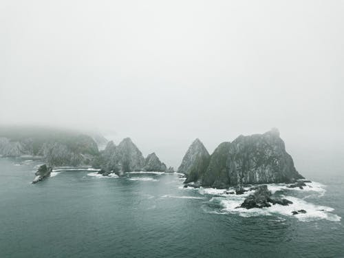 An Aerial Footage of a Rock Formation Surrounded by the Sea