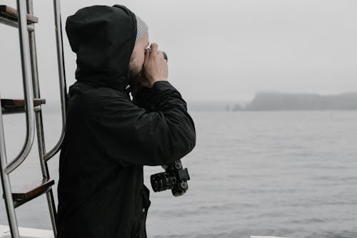 Man Taking Picture of Sea