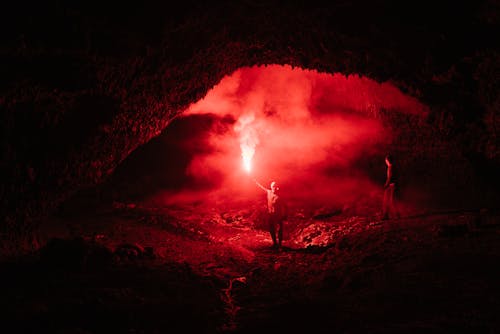 People with Red Light in Cave