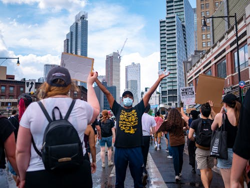 Man Holding Water Bottles at a Political Demonstration