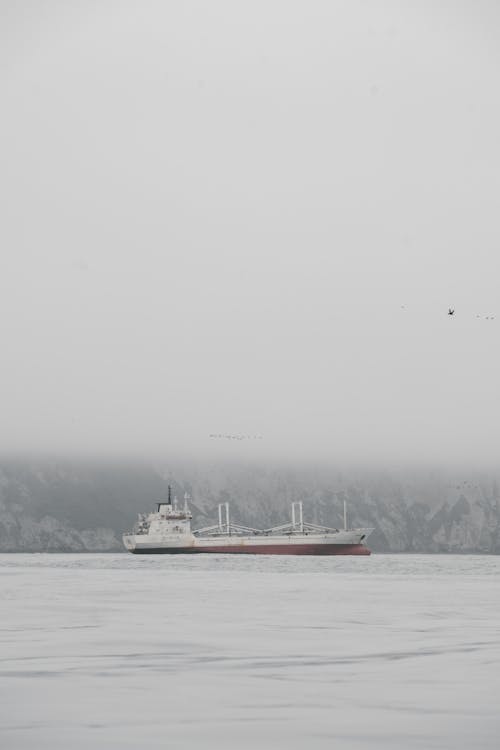 Fog over Ship near Rocks