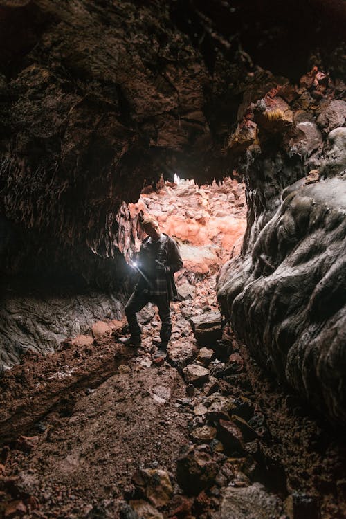 Man with Light Exploring Cave