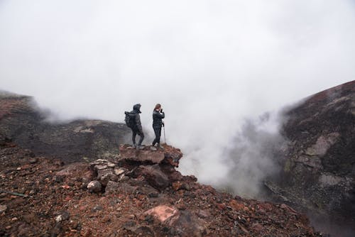 People on Rock Hiking near Volcano Crater