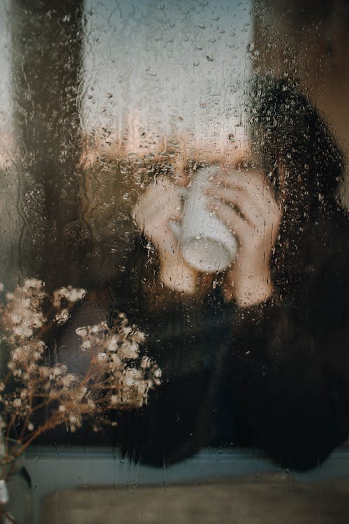 Person Behind Glass Window Drinking Coffee · Free Stock Photo