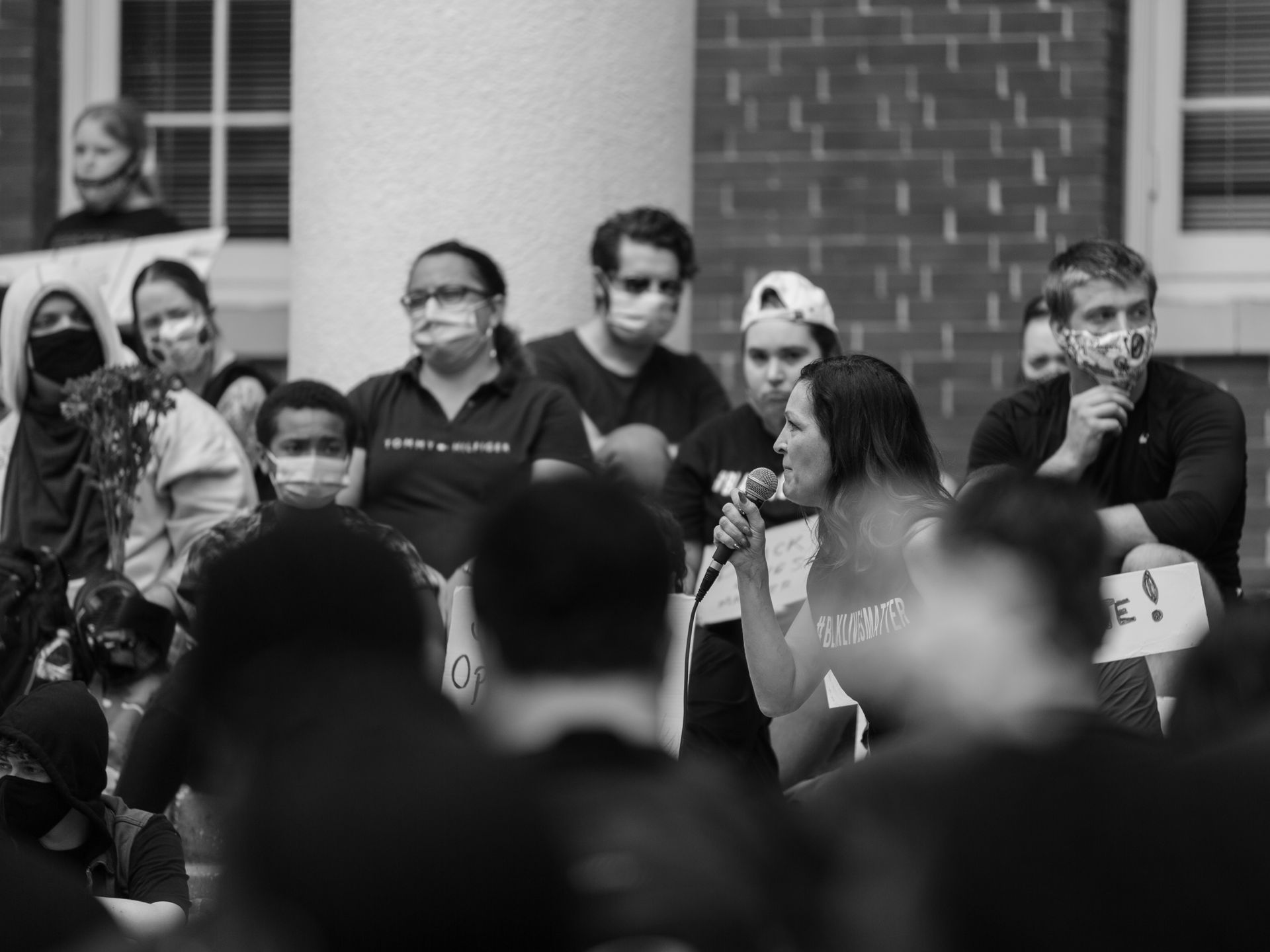 Black and white photo of a peaceful protest with people speaking in Brooksville, Florida.
