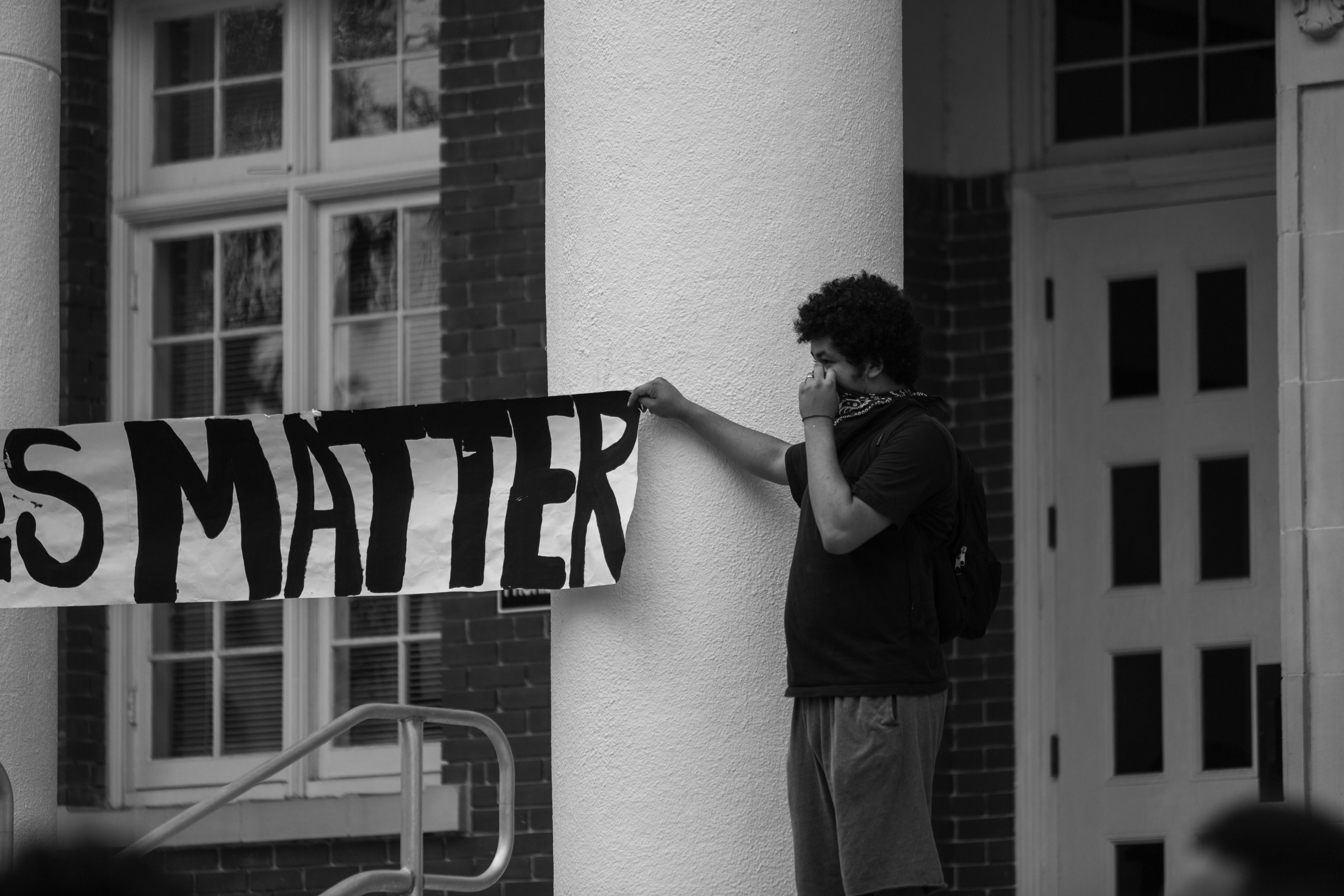 Man Holding Up Protest Sign · Free Stock Photo