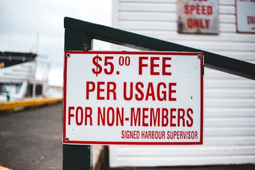 Photo by Erik Mclean Close-up of a sign indicating a $5 usage fee for non-members at a harbor.