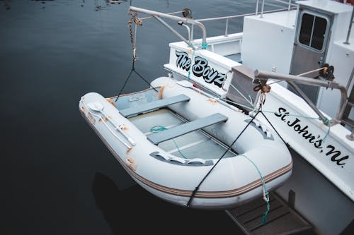 Free High angle lifeboat attached to back side of contemporary vessel moored on calm river surface Stock Photo