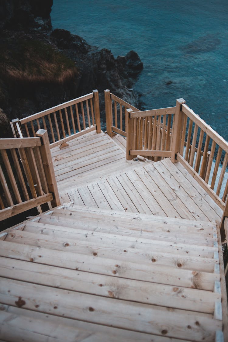 Wooden Steps On Rocky Cliff Leading To Sea