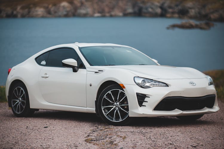 Fancy White Car Parked On Lake Shore