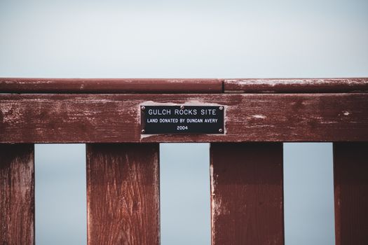 Nameplate with text on wooden fence