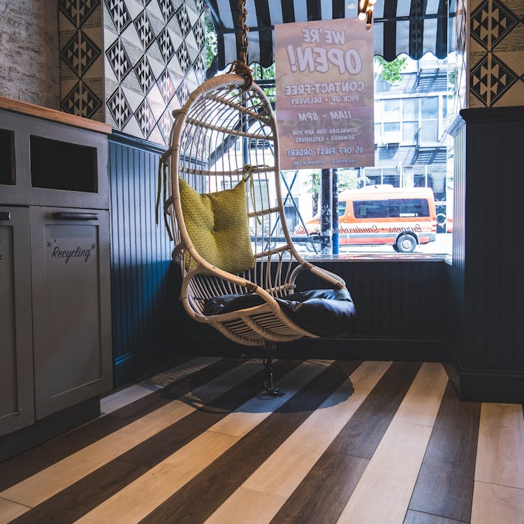 Wicker egg chair hanging in modern cafeteria