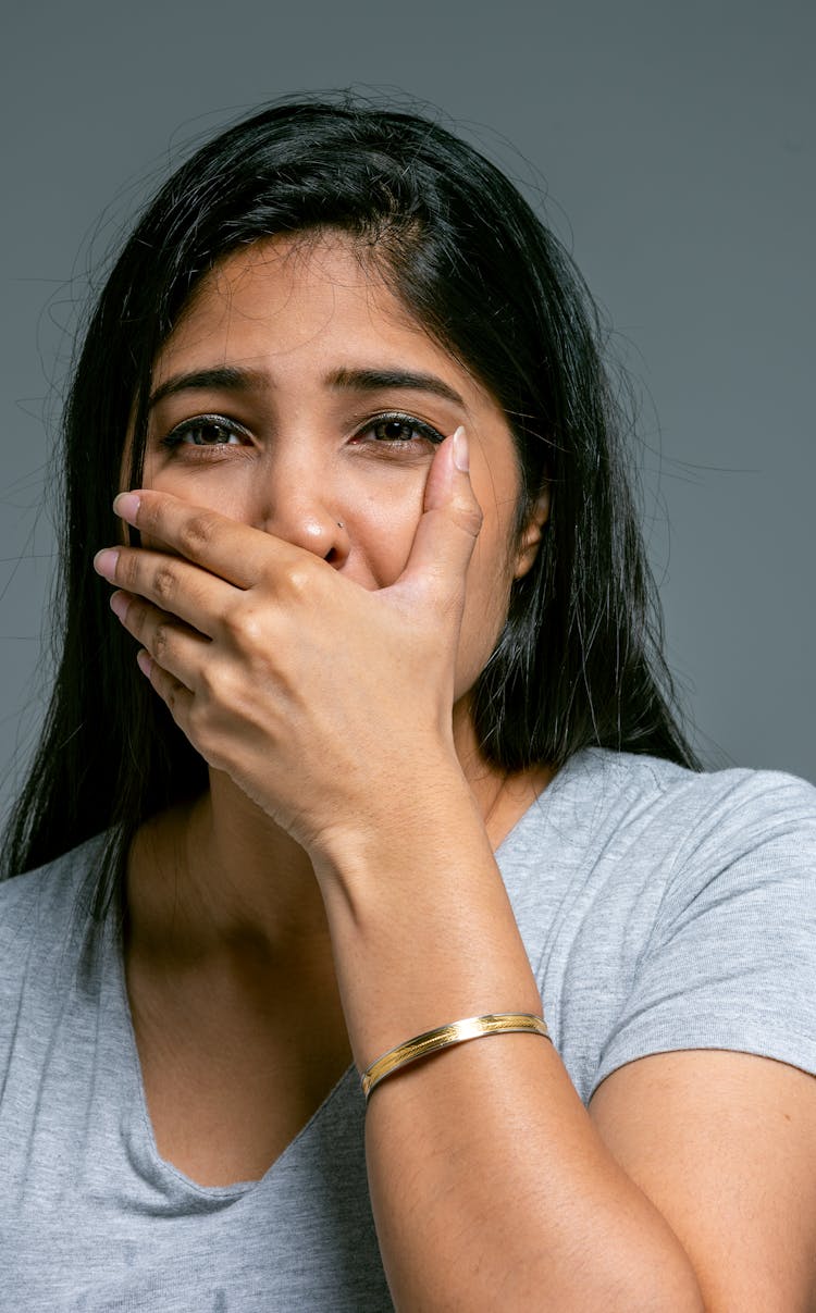 Woman Covering Her Mouth With Her Hand