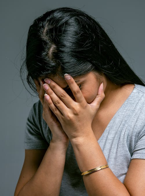 Free Woman Hiding Her Face in Hands Stock Photo