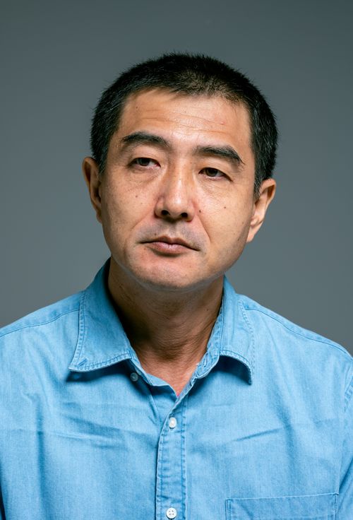 Free Studio portrait of a mature man in a blue shirt looking contemplative. Stock Photo