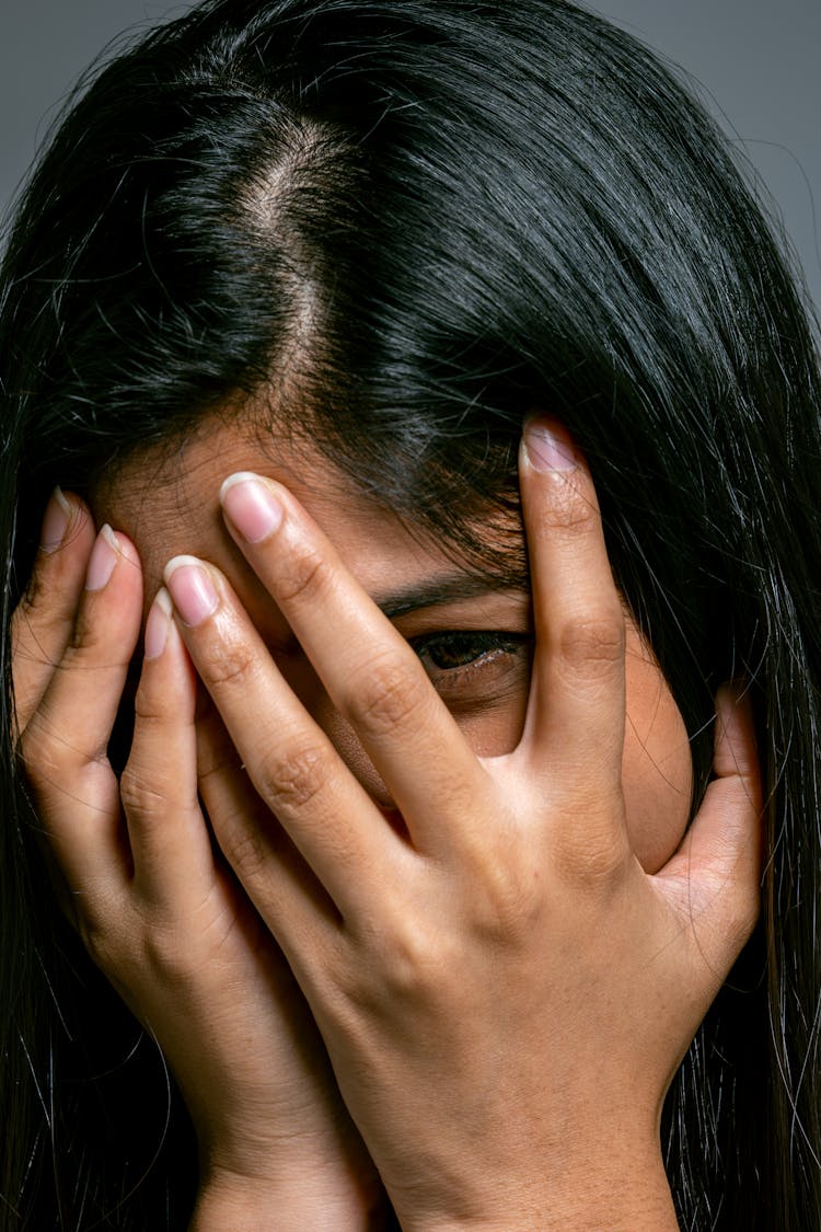 Brunette Woman Hiding Face In Hands