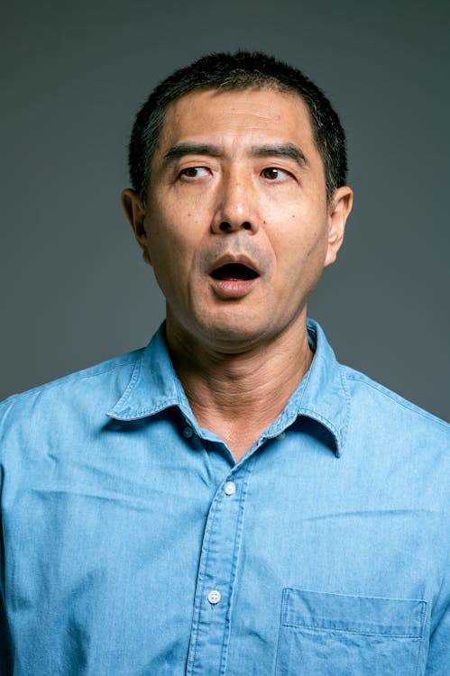 Free Man in Blue Button Up Shirt Astonished Stock Photo