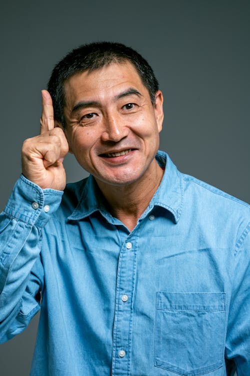 Foto d'estoc gratuïta de asiàtic, botó amunt, camisa blava