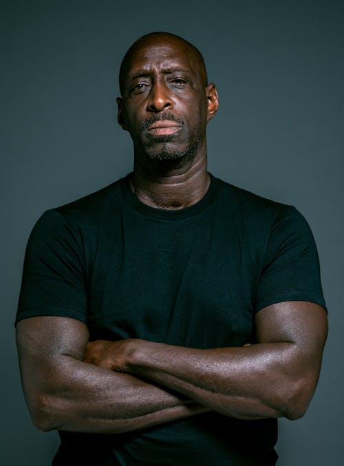 Man in Black Crew Neck T-shirt with Arms Crossed