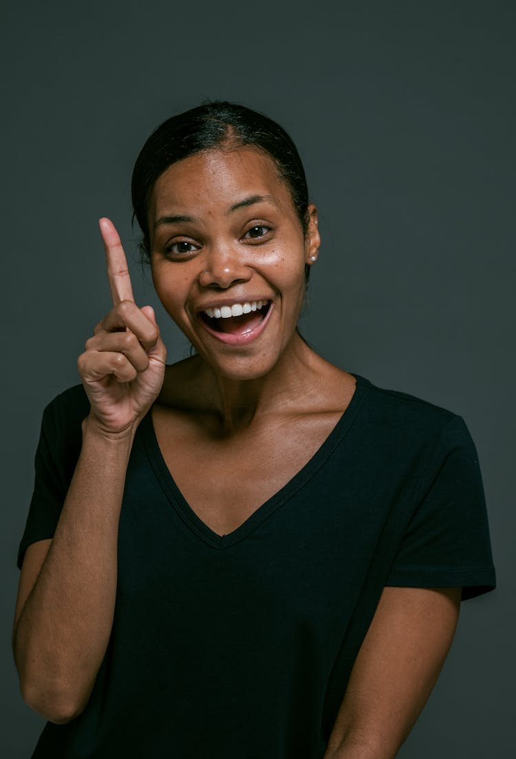 Woman In Black V Neck T-shirt Showing Her Pointing Finger