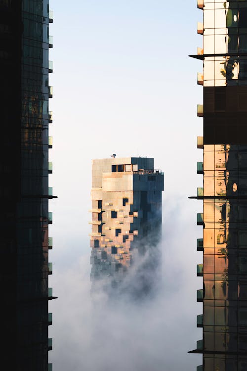 Modern Buildings Over White Clouds