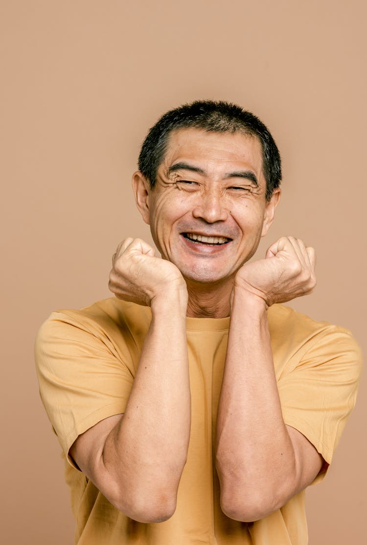 Man In Yellow Crew Neck T-shirt With An Expressive Smile