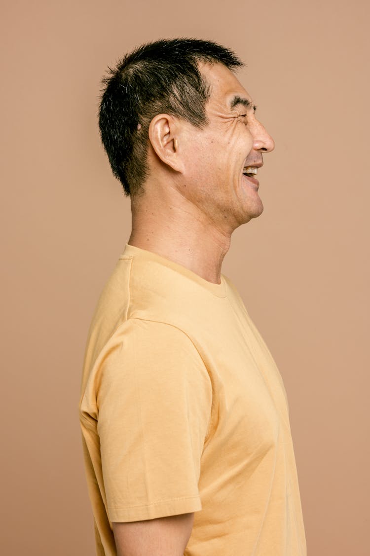 Side View Of A Man Wearing A Wide Smile