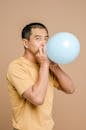 Man Blowing Up a Balloon