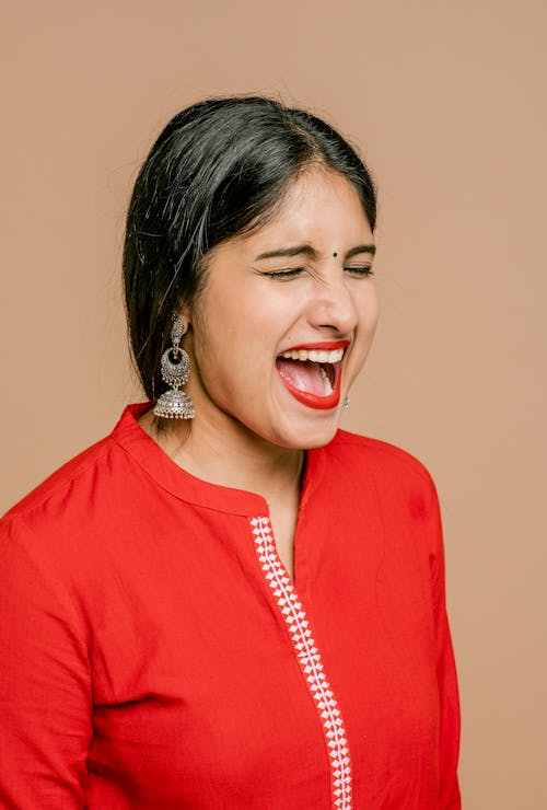 Free A Woman in Red Dress Screaming Stock Photo