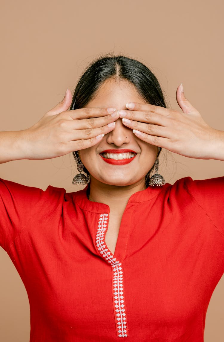 A Woman Covering Her Eyes With Her Hands