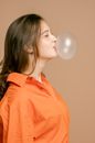A Pretty Woman Blowing a Bubble Gum