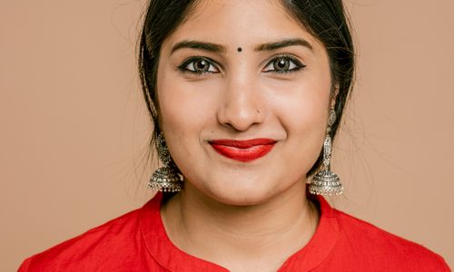 Free Charming close-up portrait of a South Asian woman with red lipstick and traditional jewelry. Stock Photo